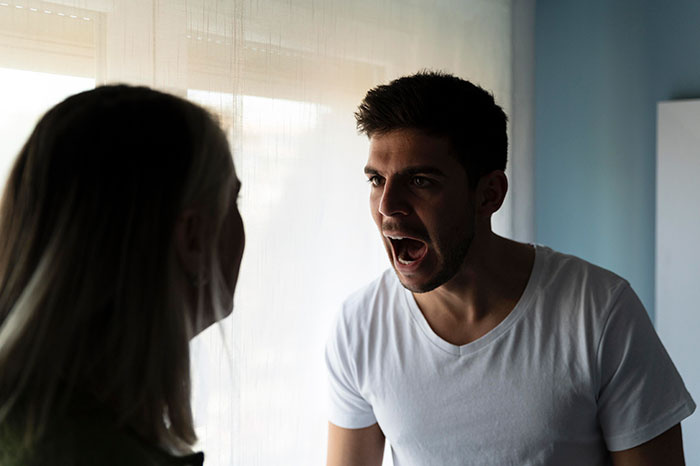Man in a white shirt angrily confronting a woman near a window, depicting tension in a friend wife drunk hookup scenario. Man in a white shirt angrily confronting a woman near a window, depicting tension in a friend wife drunk hookup scenario.
