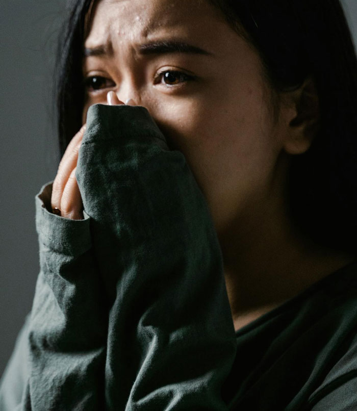 Woman looking distressed and upset, reflecting the emotional impact of refusing to babysit her autistic nephew.