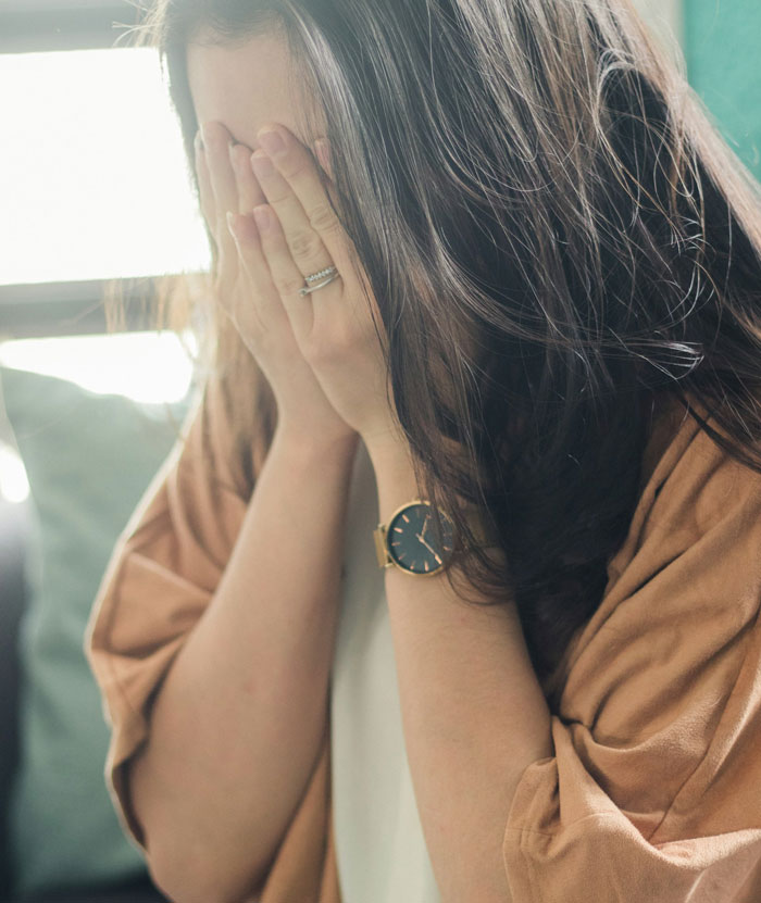 Woman covering face in distress, symbolizing pain from husband hiding affair for 9 years and family secrets emerging. Woman covering face in distress, symbolizing pain from husband hiding affair for 9 years and family secrets emerging.