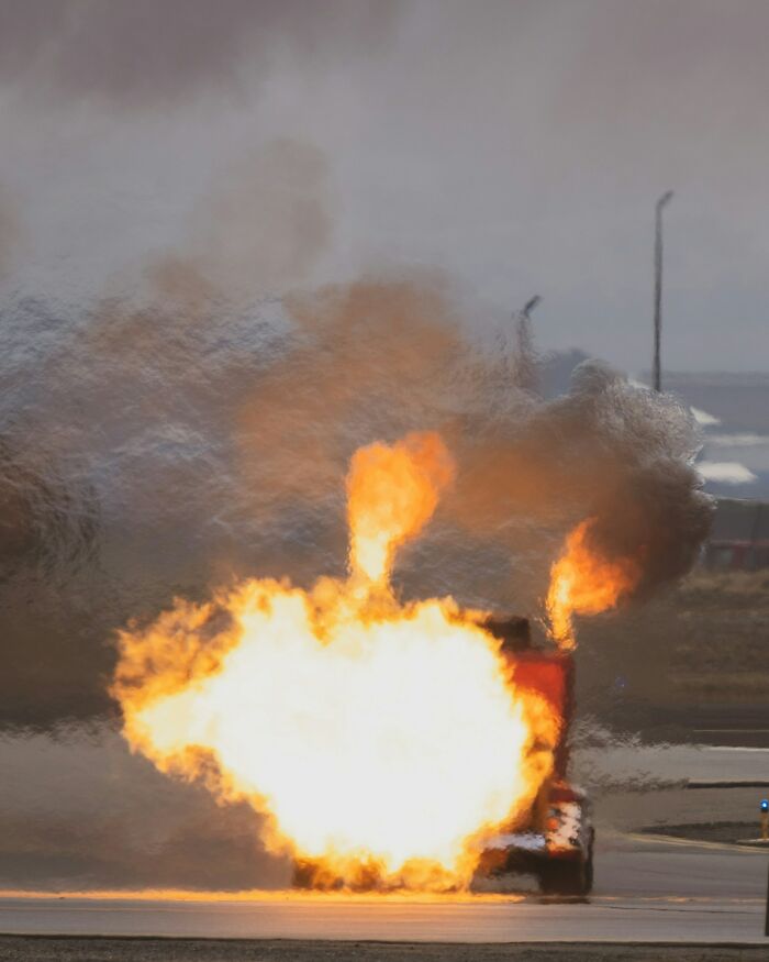 A vehicle engulfed in flames with thick smoke rising, illustrating intense moments from crazy survival situations.