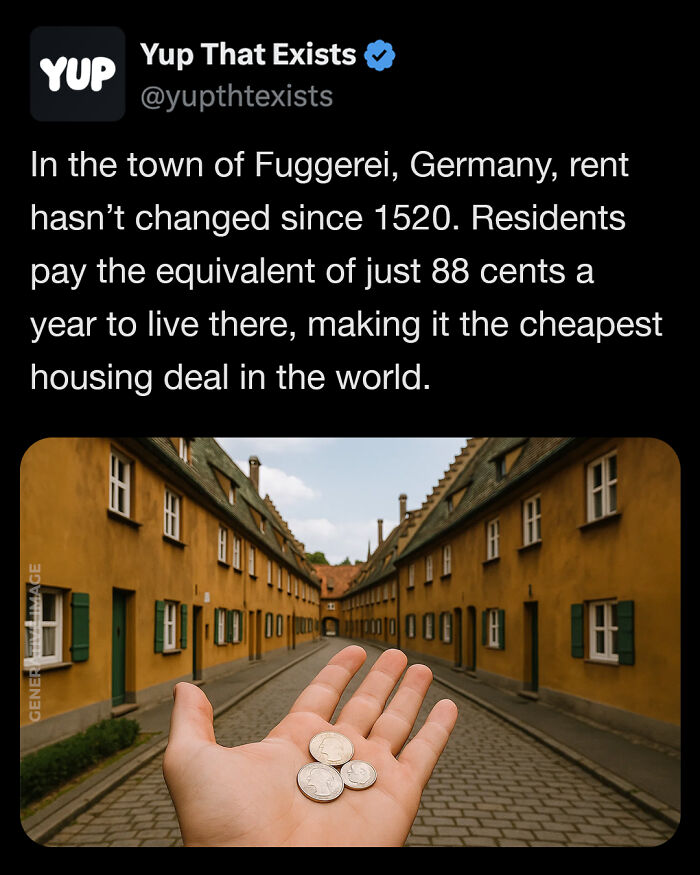 Hand holding three coins on a cobblestone street with historic yellow houses in Germany showing a weird real housing deal.