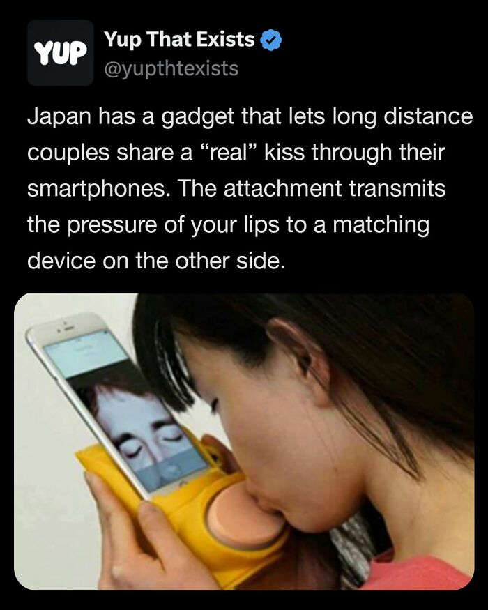 Woman using a Japanese gadget that transmits real kiss pressure through smartphones for long distance couples.