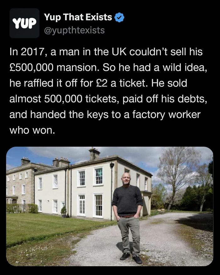 Man standing in front of a UK mansion that was raffled off, an example of weird things that sound made up but are real.