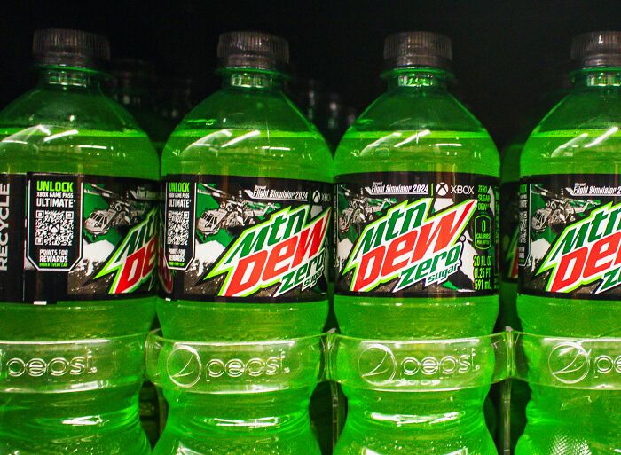 Rows of Mountain Dew Zero soda bottles displayed on a store shelf, highlighting shopping habits and consumer products.
