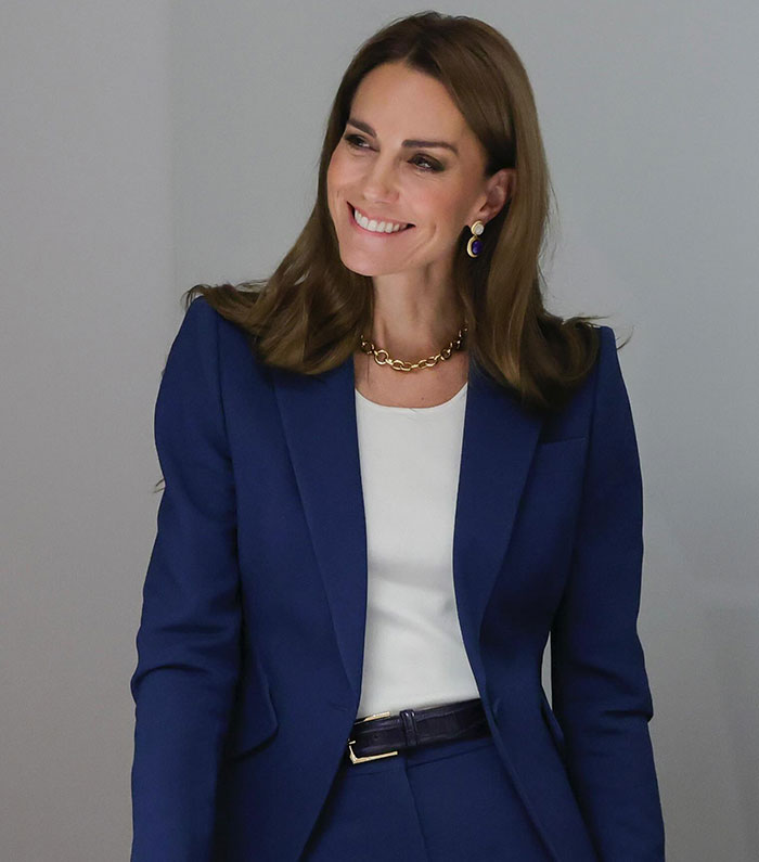 Kate Middleton smiling in a blue suit as Princess Diana's hairdresser responds to trolls about blonde hair. Kate Middleton smiling in a blue suit as Princess Diana's hairdresser responds to trolls about blonde hair.