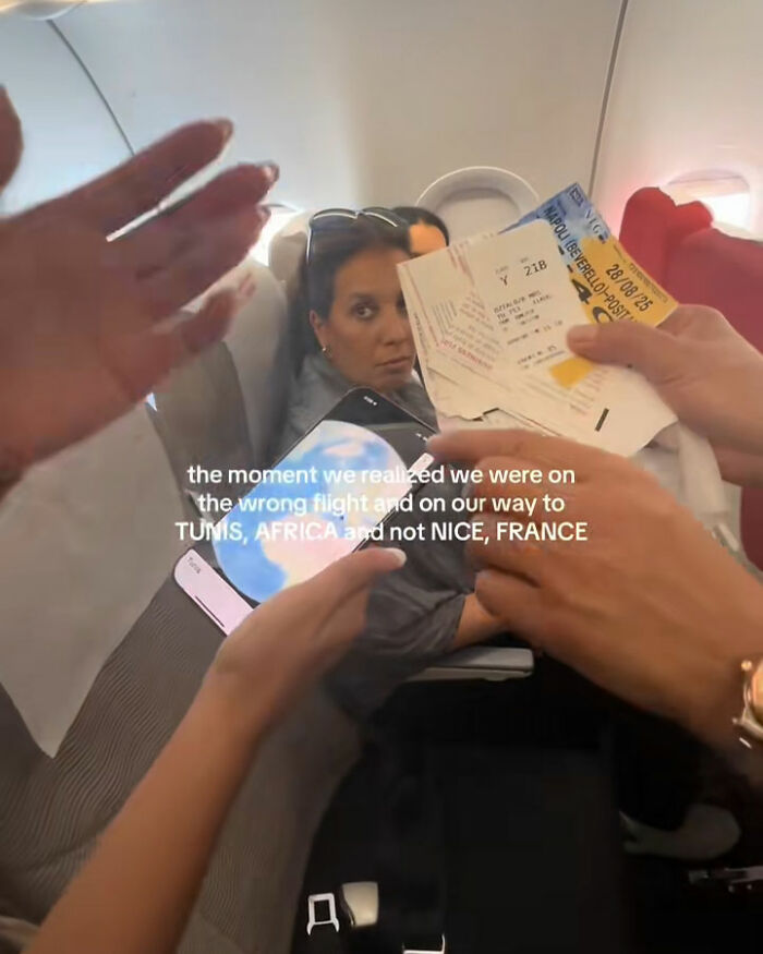 Tourists realize mid-flight they are headed to Africa instead of France, showing tickets and signs of confusion on plane.