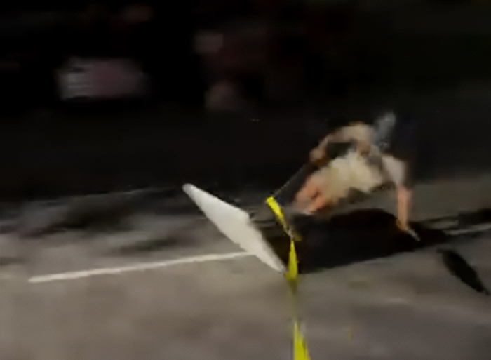 Person falling on street at night, related to viral TikTok trend causing catastrophic injuries and lifeless teen.