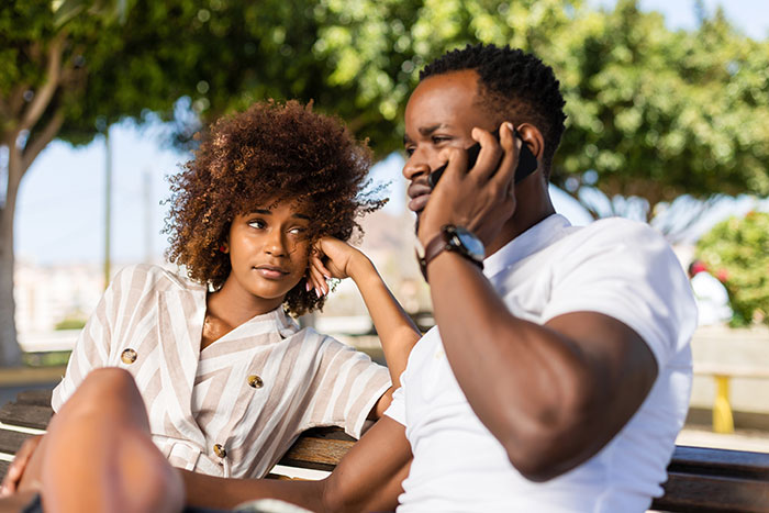 Man and woman sitting on park bench outdoors, reflecting on mountain biking meltdown early in the morning.