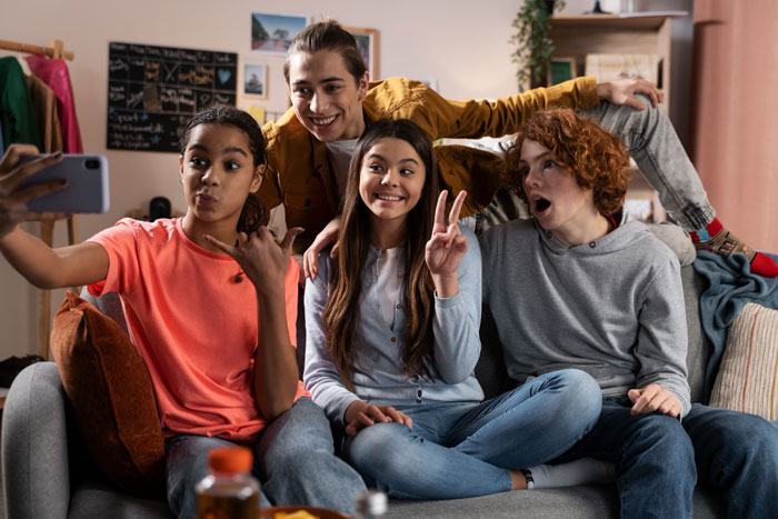 Group of teens taking a selfie together at home, depicting friendship before a teen suffers allergic reaction at a friend's house. Group of teens taking a selfie together at home, depicting friendship before a teen suffers allergic reaction at a friend's house.