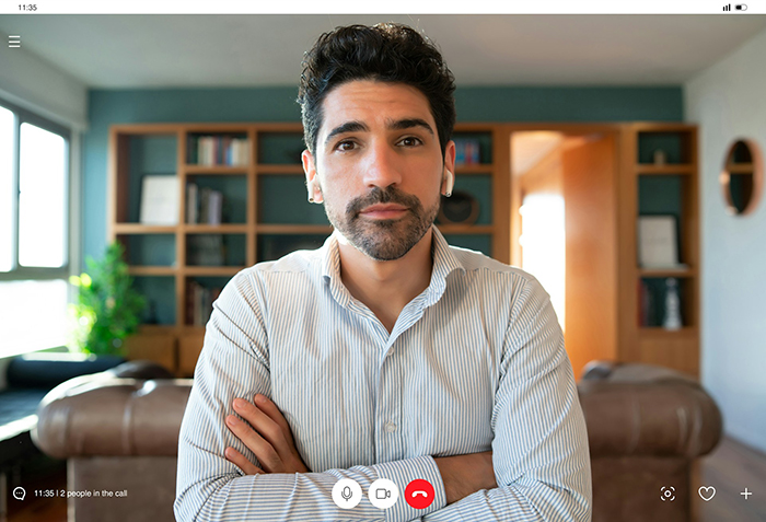 Man in a virtual therapy session at home, looking serious and thoughtful during a private video call. Man in a virtual therapy session at home, looking serious and thoughtful during a private video call.