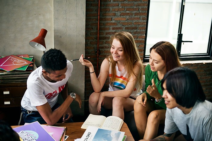 Group project discussion with diverse students showing teamwork challenges and lazy teammates relying on the smart member.