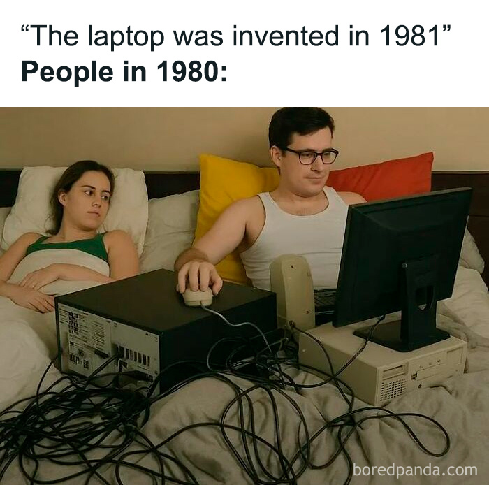 Couple in bed with vintage desktop computer and cables, illustrating funny programmer memes created when not coding.