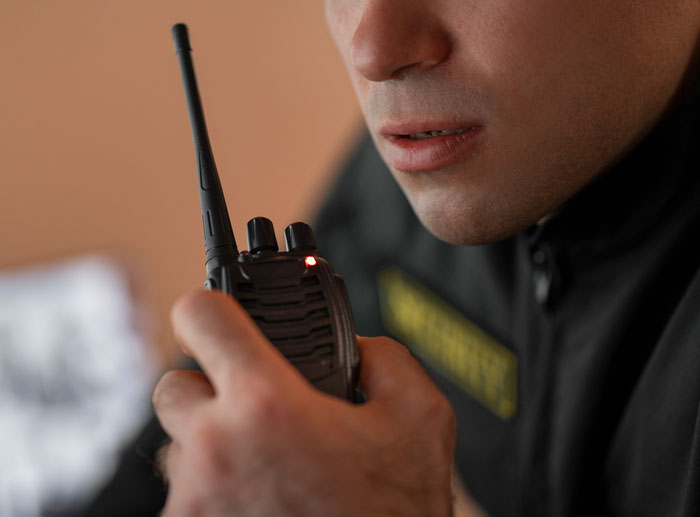 Close-up of a cop holding a radio, sharing the most horrible things they’ve ever witnessed on duty.