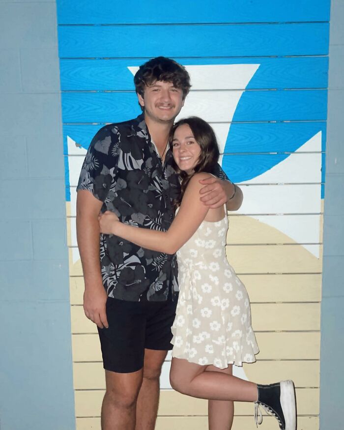 Young couple posing in front of a blue and beige wall, unrelated to Bryan Kohberger's mom discussing Idaho crimes.