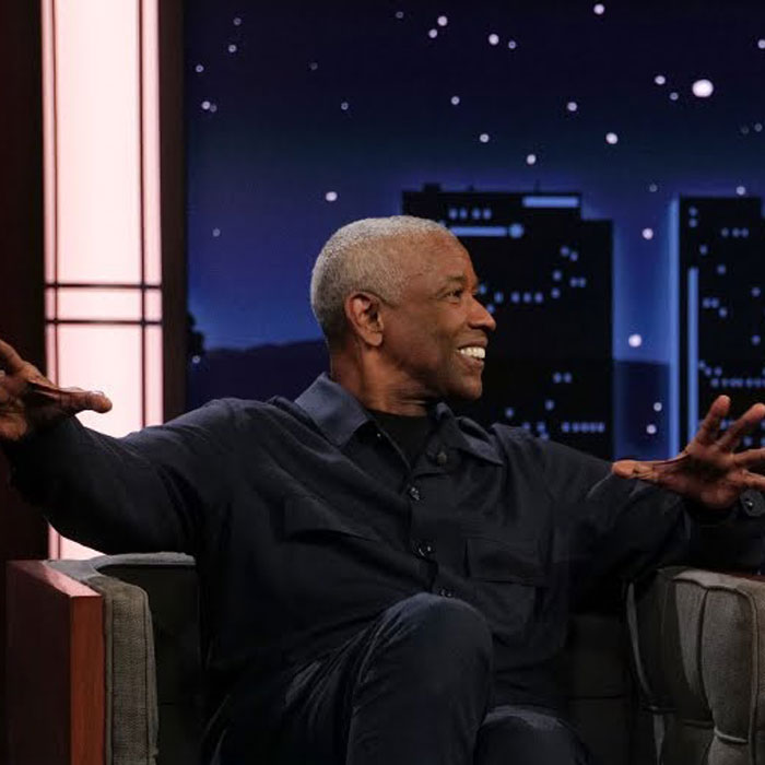 Denzel Washington smiling and gesturing while seated on a talk show set discussing correct name pronunciation. Denzel Washington smiling and gesturing while seated on a talk show set discussing correct name pronunciation.