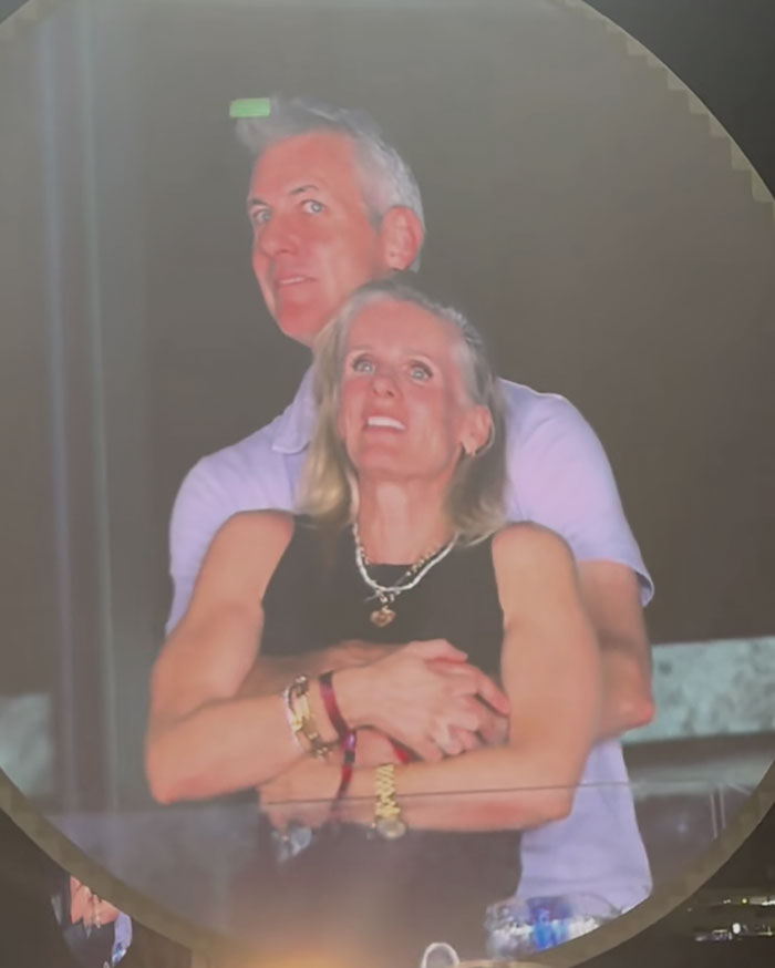 Couple embracing at an event, related to Coldplay kiss cam scandal involving ex-astronomer HR chief Kristin Cabot divorce news.