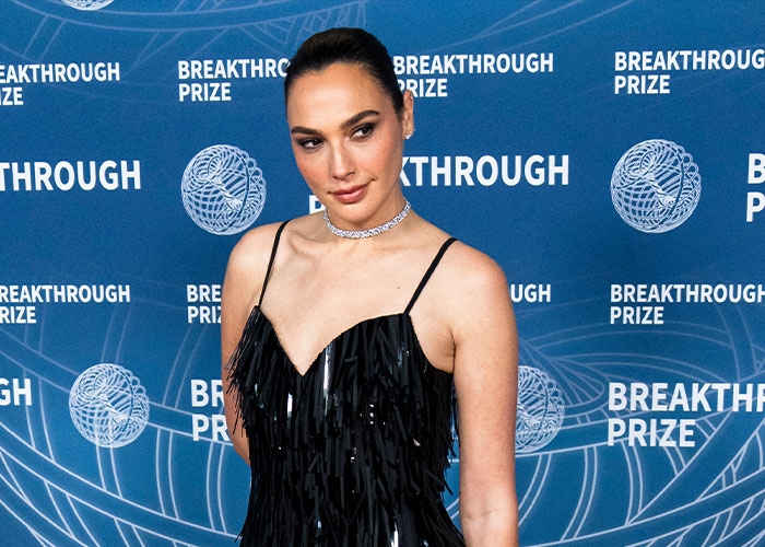 Gal Gadot posing in a black dress at a Breakthrough Prize event, relating to Venice Film Festival controversy.