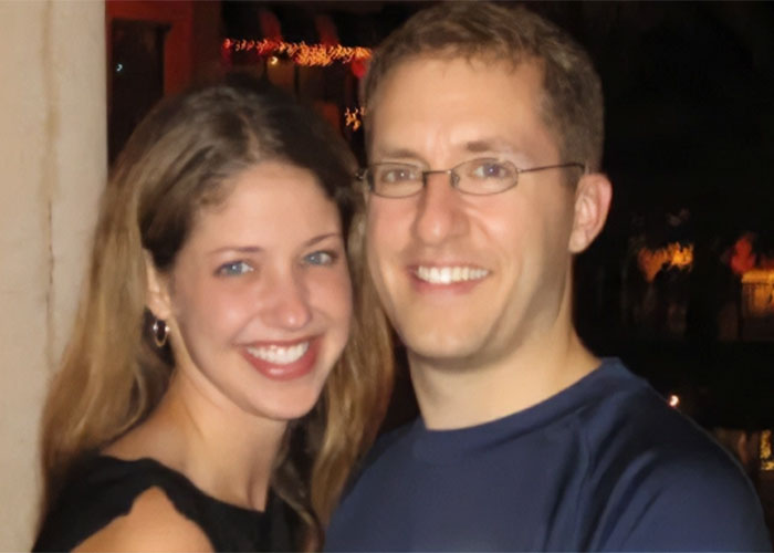 Smiling couple posing closely at night with blurred lights in the background, juror breaks silence on grandma's court meltdown.