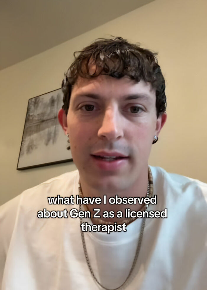 Therapist explaining Gen Z clients' troubling behavior in a casual indoor setting with text overlay on screen. Therapist explaining Gen Z clients' troubling behavior in a casual indoor setting with text overlay on screen.