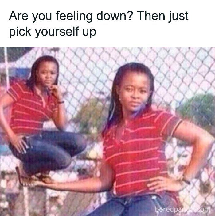 Person wearing a red striped shirt holding a miniature version of themselves near a chain-link fence, cringe-worthy but wholesome post.