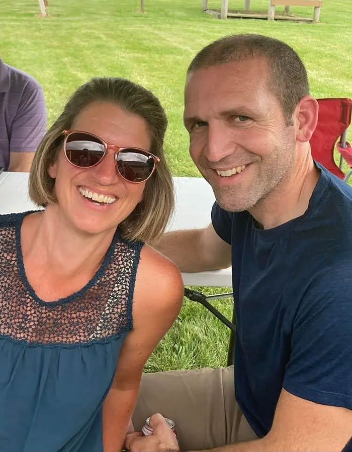 Smiling couple sitting outdoors with husband&rsquo;s final texts to wife revealed after he faked passing to be with mistress.