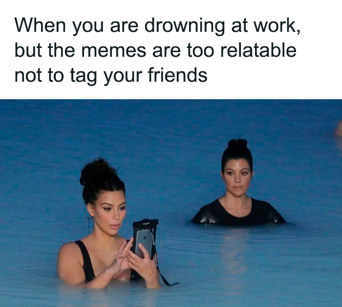 Two women waist-deep in water, one focused on her phone, illustrating relatable millennial struggles at work memes.