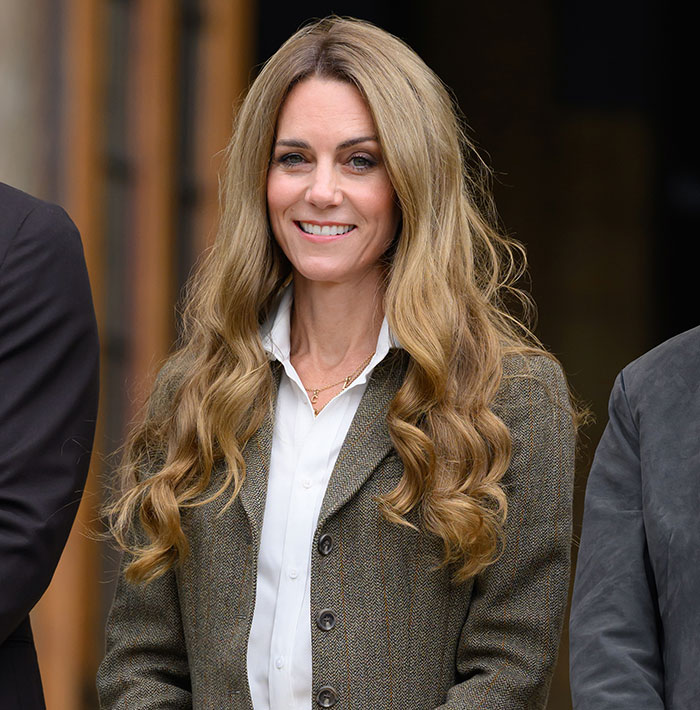 Kate Middleton smiling warmly after royal funeral, showing kindness and respect with a gentle kiss on King Charles's cheek.