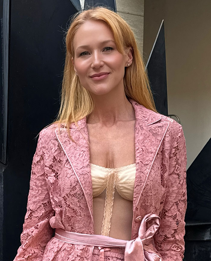 51-year-old 90s star in pink lace outfit showing toned body and sharing fitness secrets with fans in a casual setting