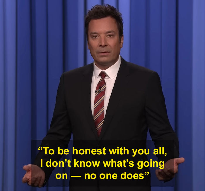 Jimmy Fallon speaking on stage in a suit and tie, addressing the Jimmy Kimmel show suspension with a serious expression.