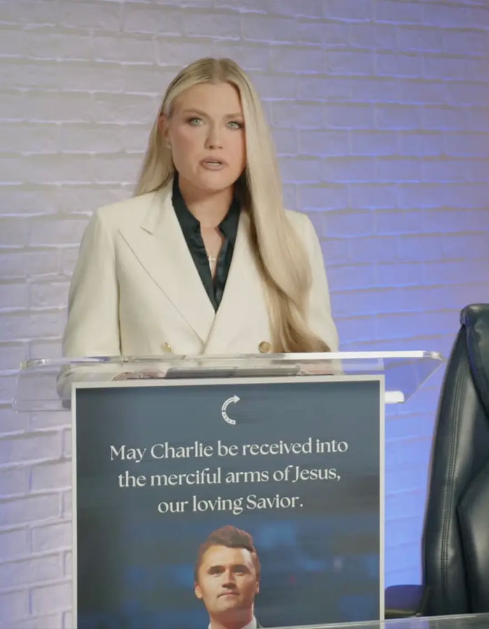 Erika Kirk speaking on justice for husband&rsquo;s assassin, standing behind a podium with a memorial message.