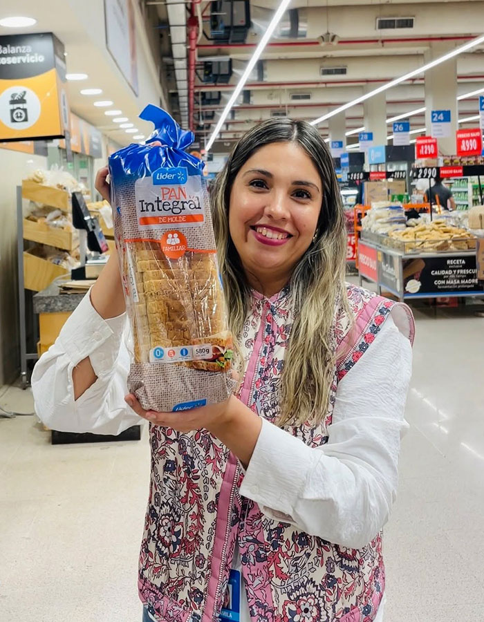 Food engineer in supermarket holding sliced bread, exposing products that trick millions of shoppers.