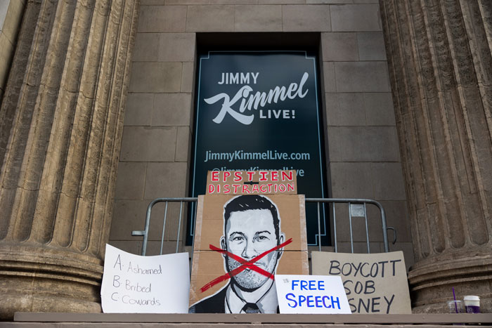 Protest signs in front of Jimmy Kimmel Live studio amid controversy and suspension over insensitive remarks.