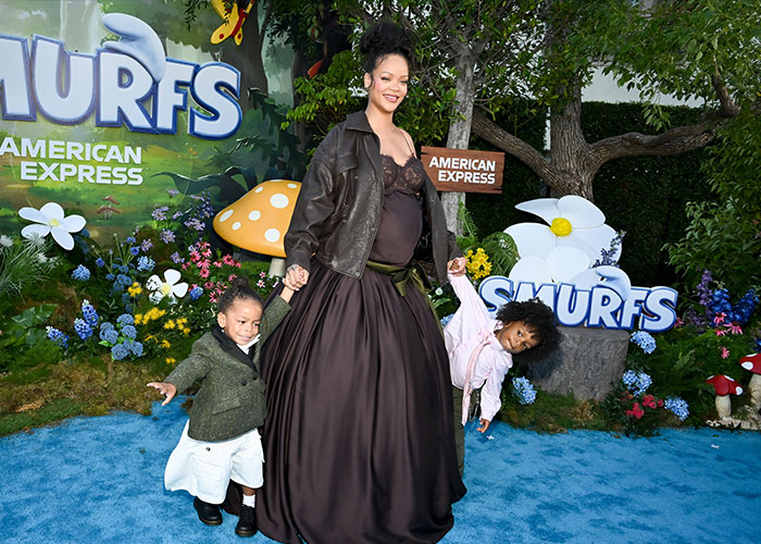 Rihanna with her children at a colorful event, as fans urge her to change the cruel name of her newborn daughter.