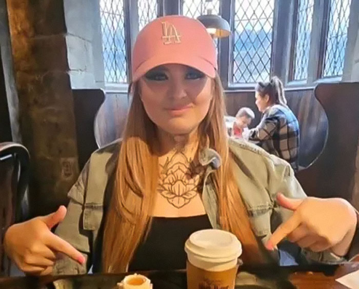 Mom who married man she met online sitting at a table with coffee, highlighting the American nightmare story.