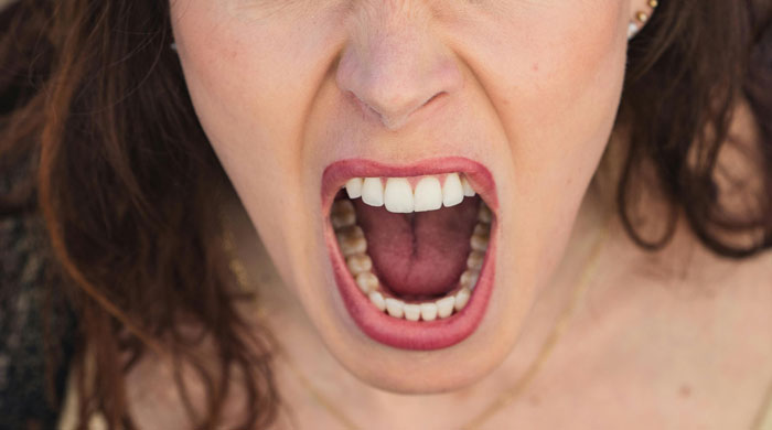 Close-up of a woman screaming in shock after catching her mom and husband in a 22-year affair.