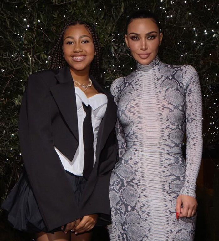 Kim Kardashian with daughter North West, 12, posing together amid controversy over middle finger dermal piercing.