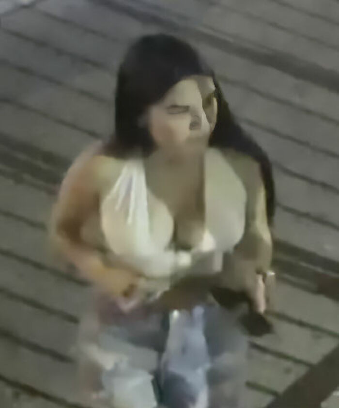 Woman in white top with long dark hair walking on a wooden surface, related to maniac driver shocking response to cops case. Woman in white top with long dark hair walking on a wooden surface, related to maniac driver shocking response to cops case.