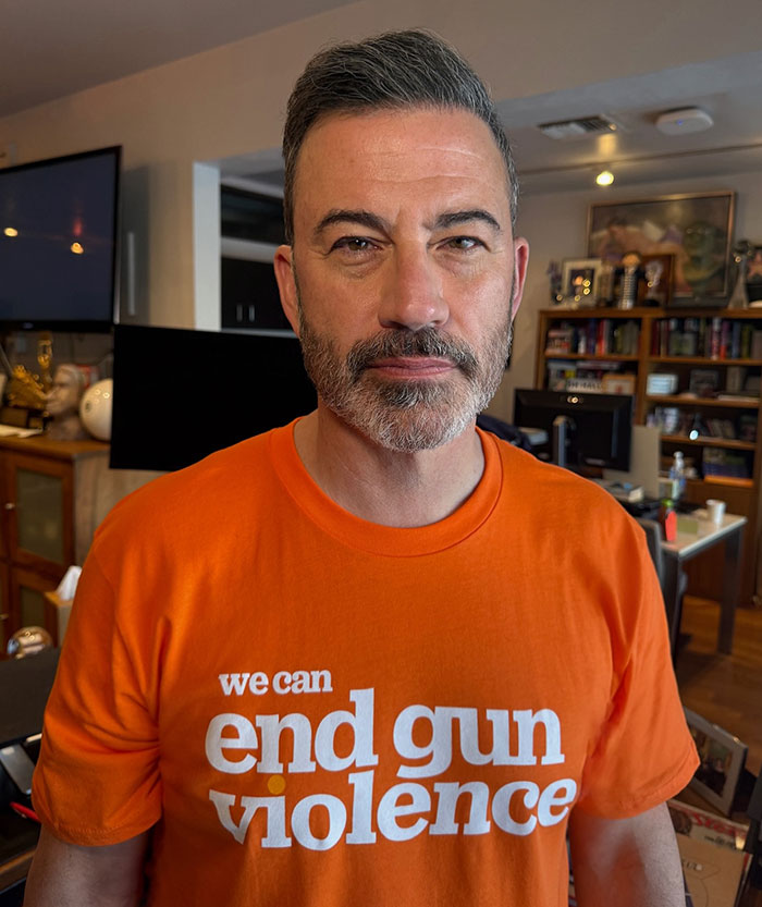 Man wearing an orange shirt with we can end gun violence text, related to Jimmy Kimmel show suspension and Hollywood reactions. Man wearing an orange shirt with we can end gun violence text, related to Jimmy Kimmel show suspension and Hollywood reactions.