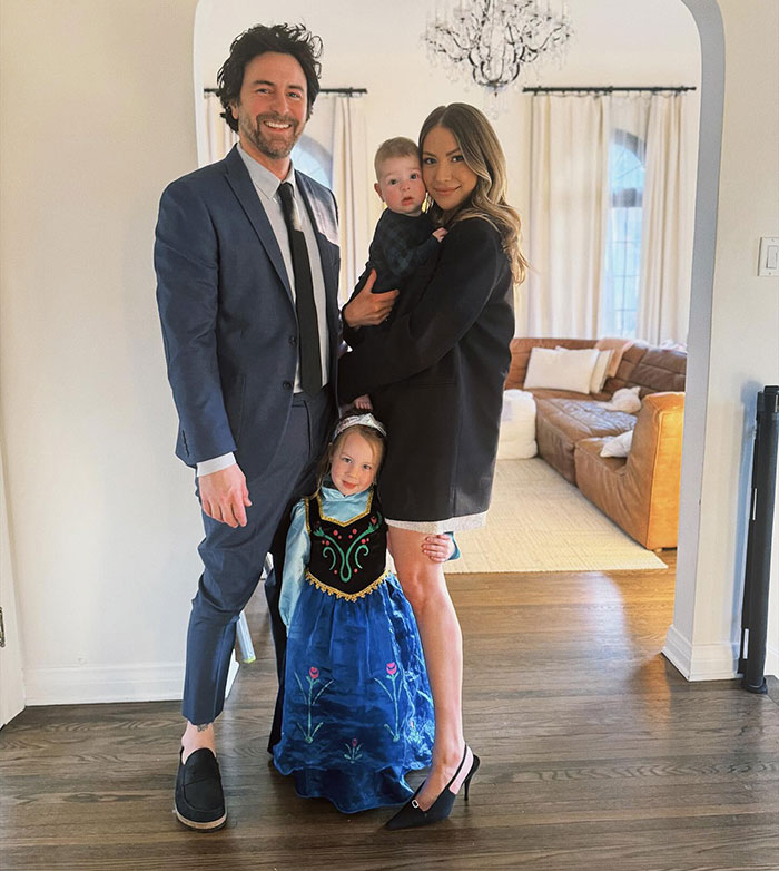 Family portrait with man in suit, woman in black blazer, and two children, illustrating reality TV star lashing out at Meghan Markle.