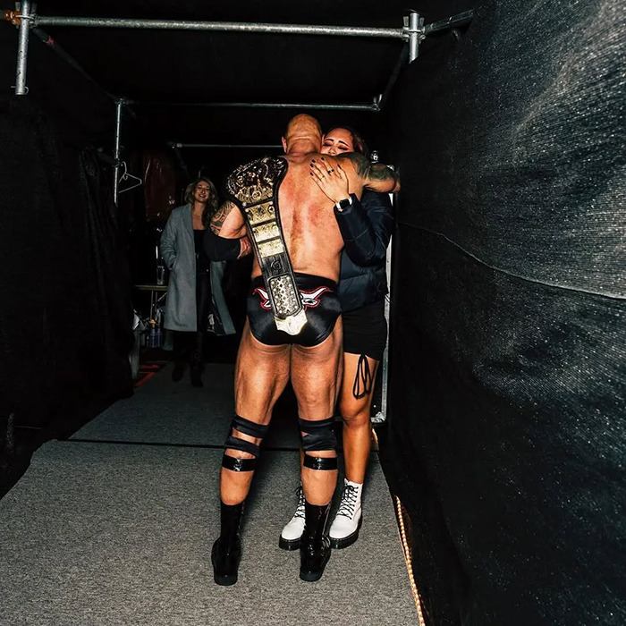 The Rock's daughter hugging a wrestler backstage with a championship belt, doubling down on remarks about Charlie Kirk. The Rock's daughter hugging a wrestler backstage with a championship belt, doubling down on remarks about Charlie Kirk.