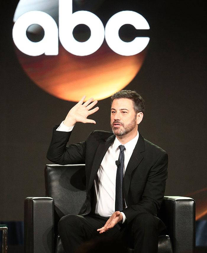 Jimmy Fallon in a black suit speaking on stage under an ABC logo, discussing Jimmy Kimmel show suspension and show insights.
