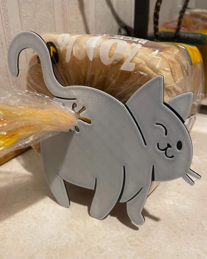Cat-shaped bread bag clip holding bread, a funny and weird purchase from unique novelty kitchen accessories.