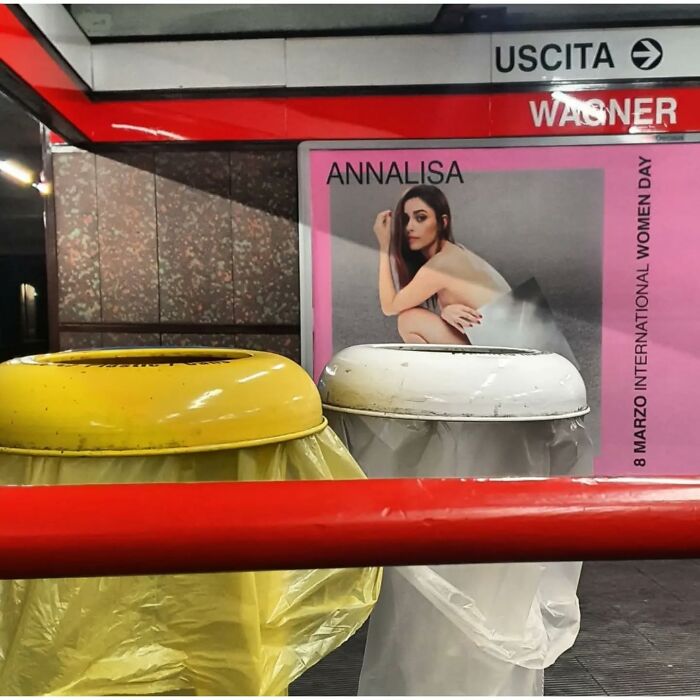 Two trash bins with yellow and white lids align with a poster in a street photo full of funny coincidences.