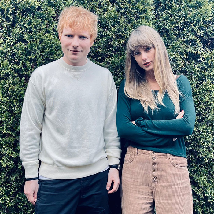 Taylor Swift standing outdoors in a green top and beige pants, stealing the spotlight with a long speech at Selena Gomez's wedding.
