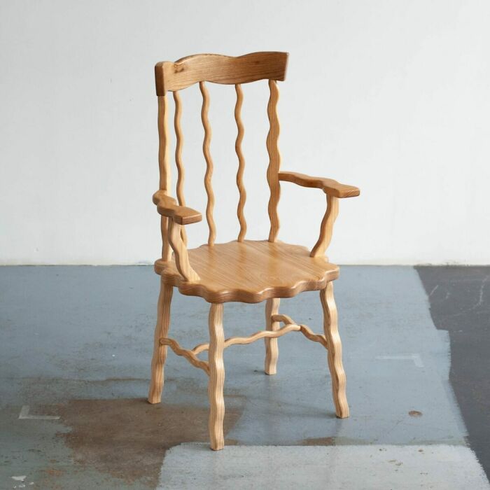 Wooden chair with wavy legs and backrest, an example of weirdest purchases people would make in a heartbeat.