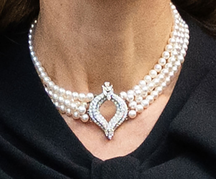 Close-up of elegant pearl necklace worn by Kate Middleton after royal funeral, symbolizing farewell to King Charles.