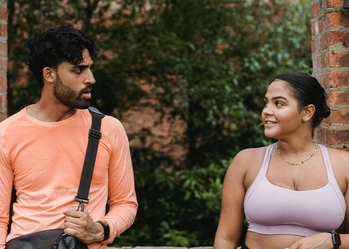 Man and woman having a casual outdoor conversation, illustrating incredible coincidences that seem fake but are true.