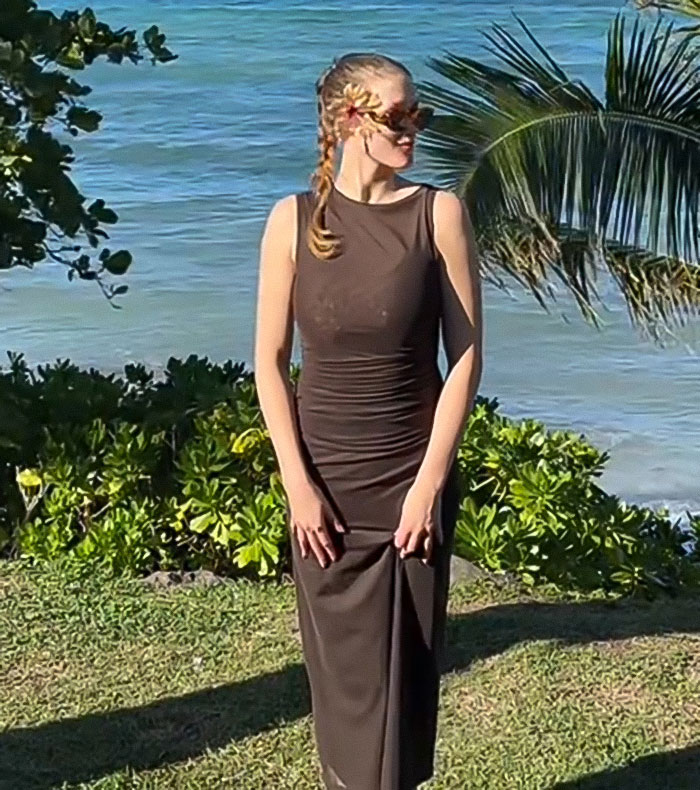 Woman outdoors near ocean, wearing sunglasses and a brown dress, highlighting matcha warning after hospital incident.