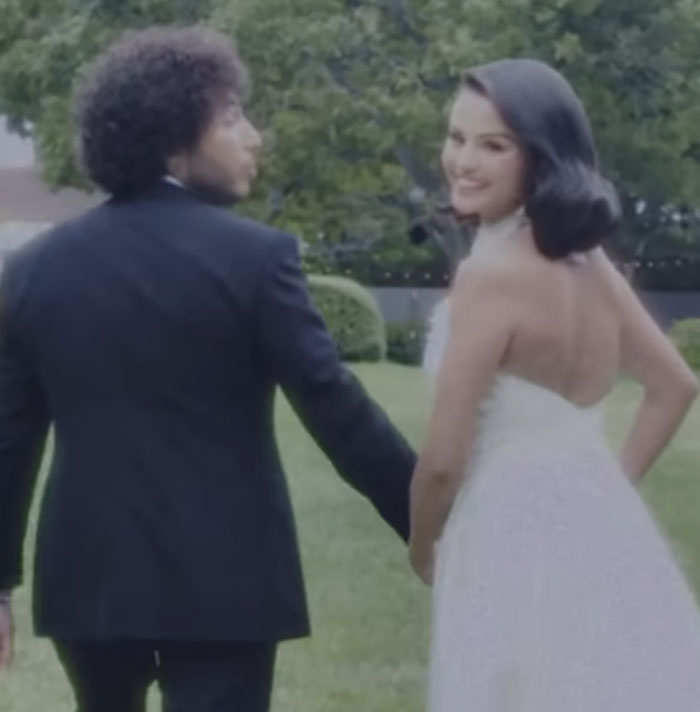 Bride in a white wedding dress and groom holding hands outdoors, related to Selena Gomez's mom wedding snub story. Bride in a white wedding dress and groom holding hands outdoors, related to Selena Gomez's mom wedding snub story.