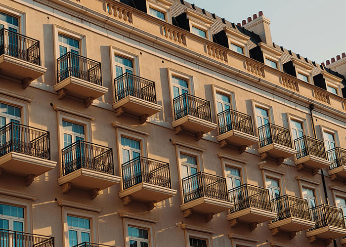 Facade of a building showing multiple balconies with symmetrical design illustrating incredible coincidences in architecture.